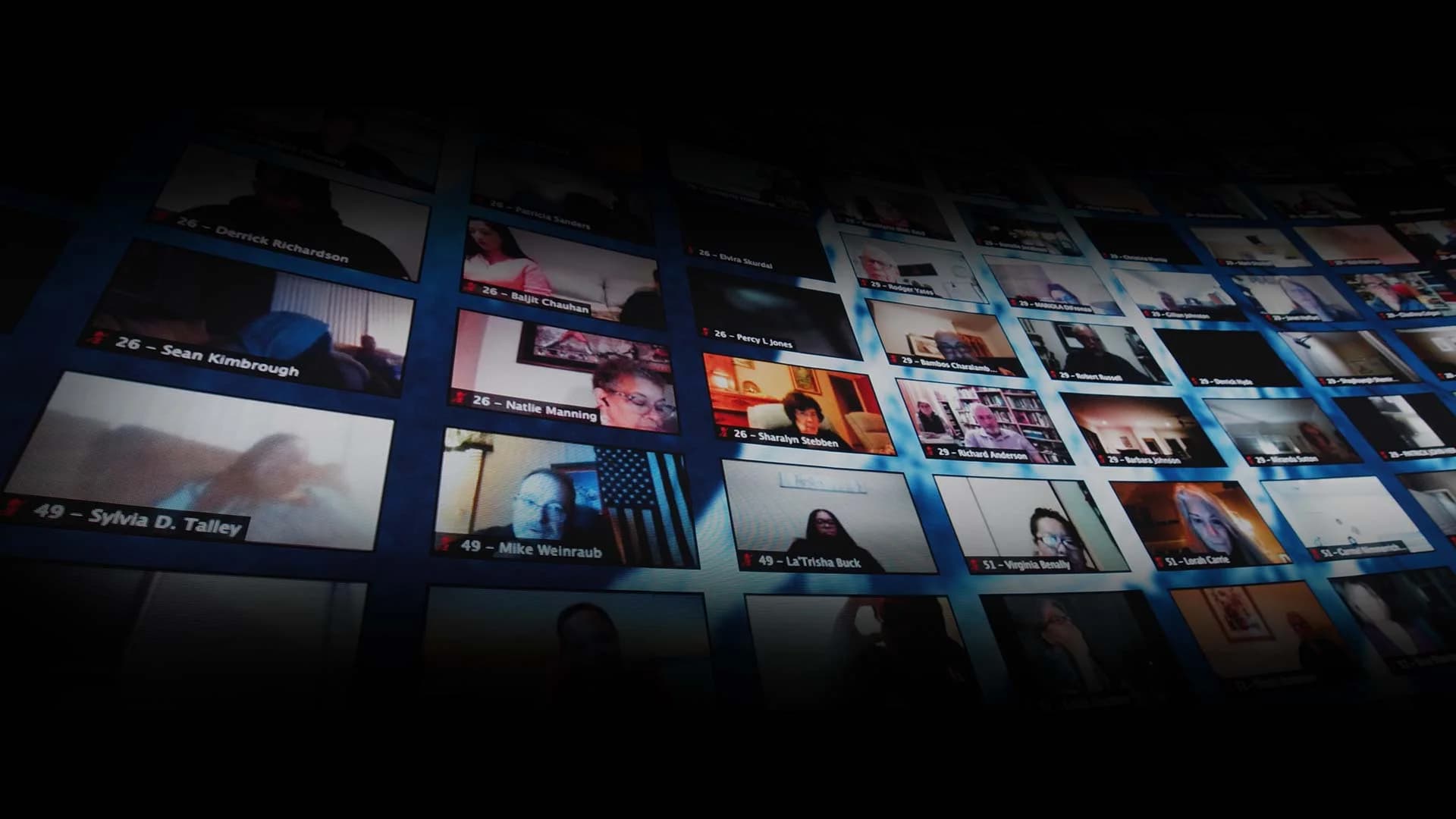Hundreds of remote attendees displayed live across the curved LED wall.