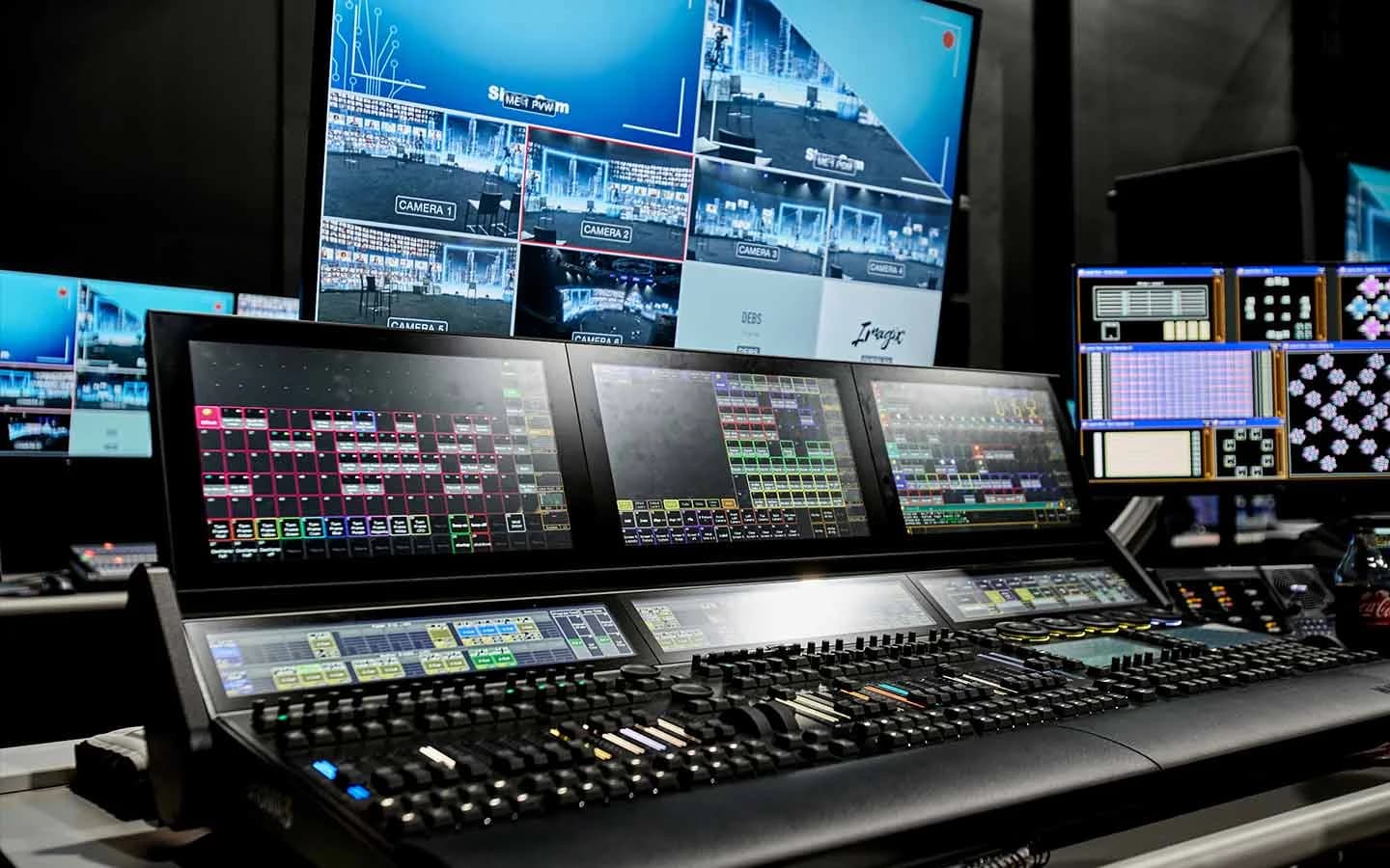 A broadcast camera on the Worre Studios stage floor facing the curved LED wall.
